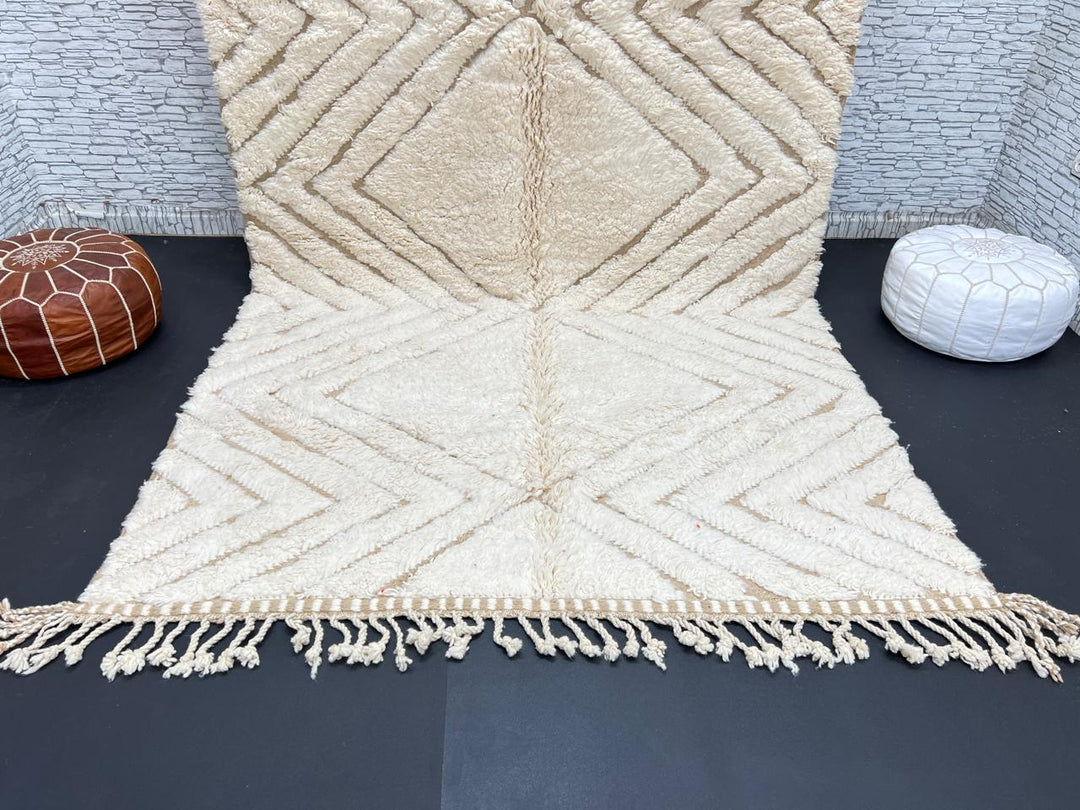Handmade beige Moroccan wool rug with chevron geometric pattern, soft plush texture