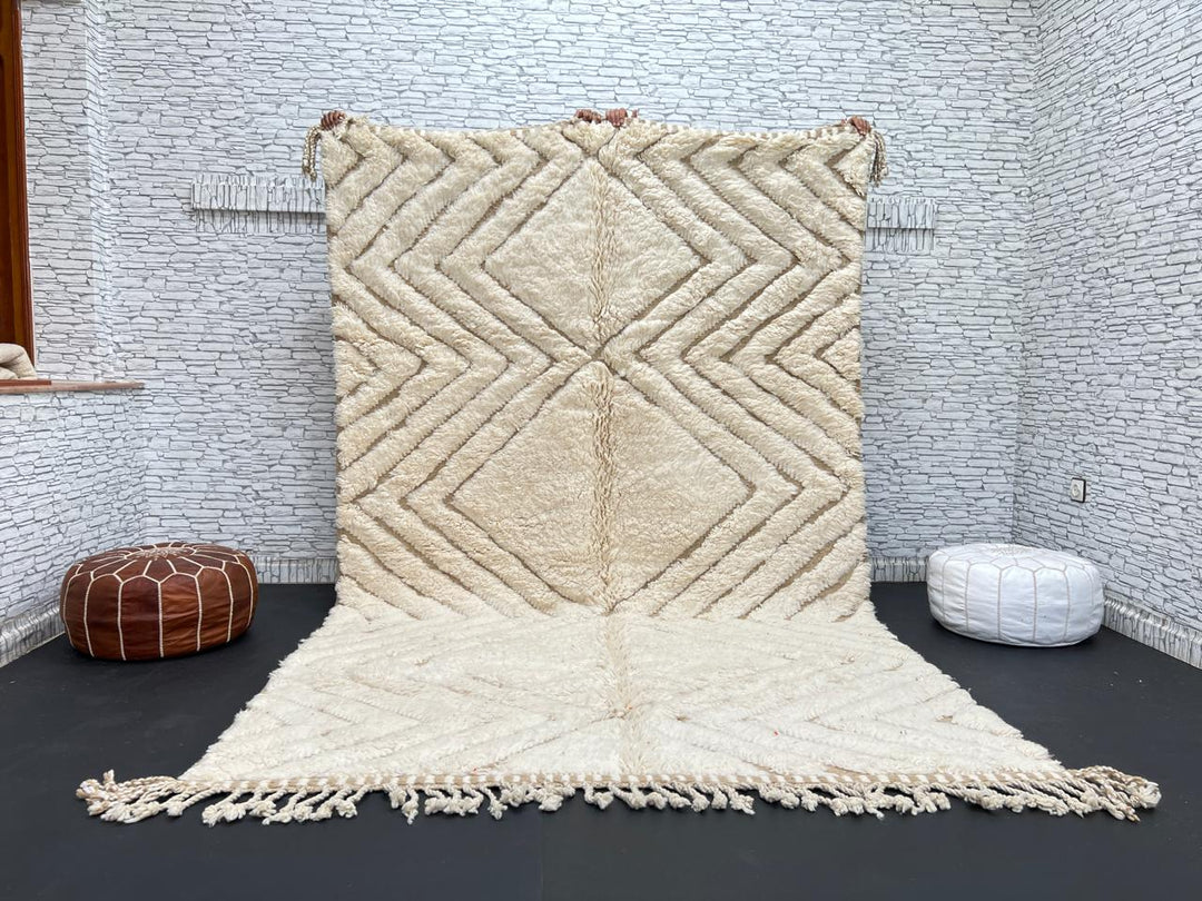 Handmade beige Moroccan wool rug with chevron geometric pattern, soft plush texture