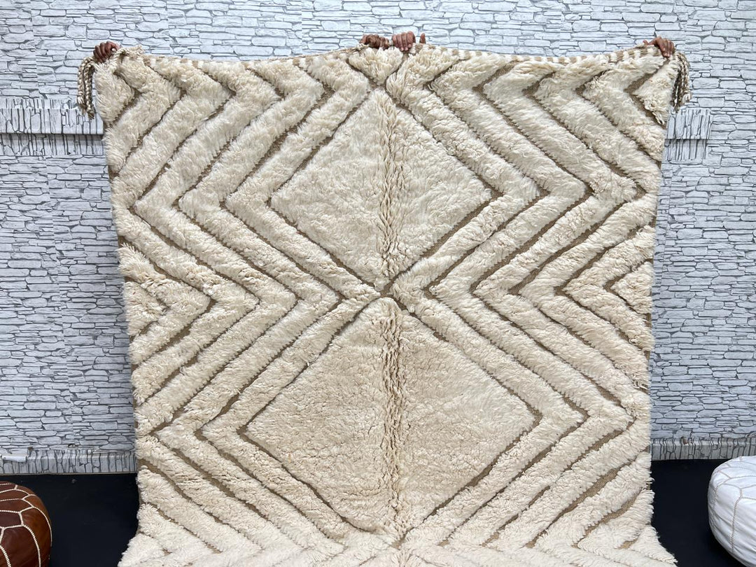 Handmade beige Moroccan wool rug with chevron geometric pattern, soft plush texture