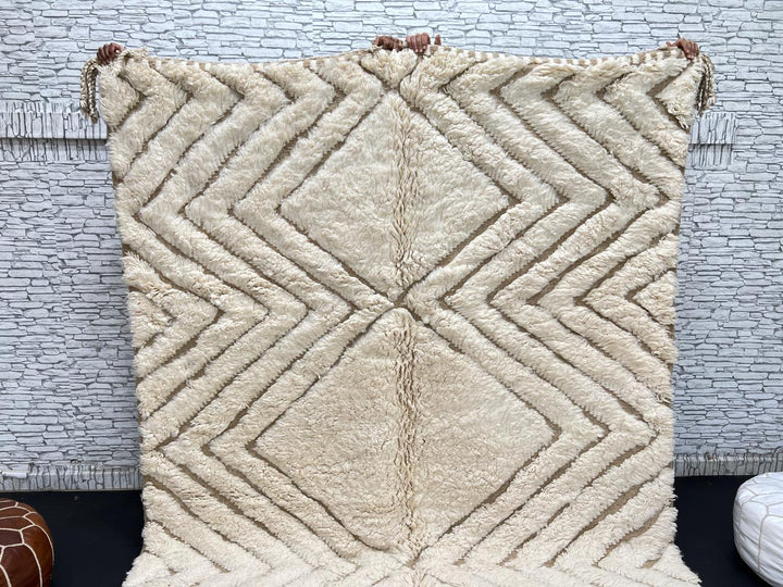 Handmade beige Moroccan wool rug with chevron geometric pattern, soft plush texture