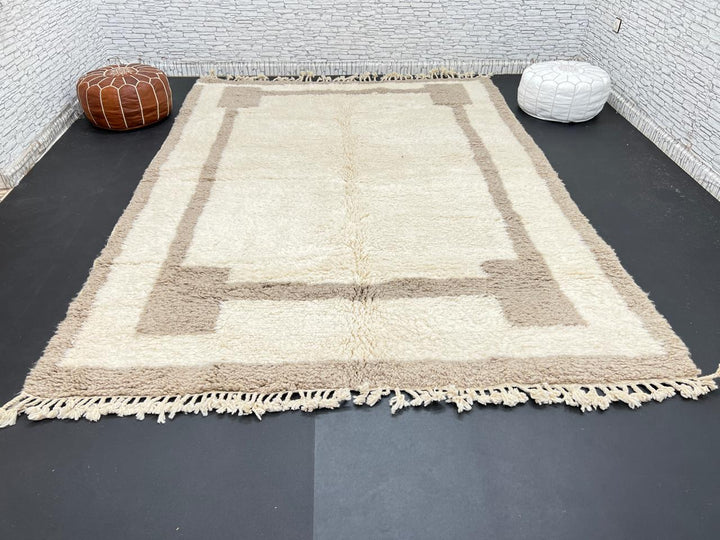Beige minimalist Moroccan wool rug with geometric border pattern