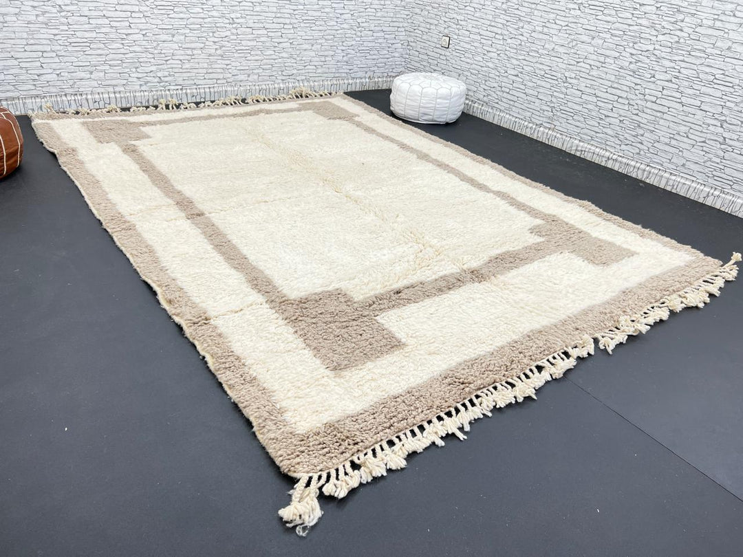 Beige minimalist Moroccan wool rug with geometric border pattern