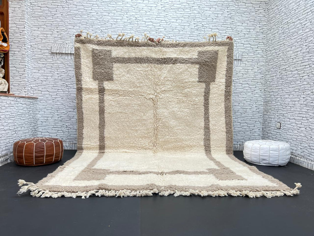 Beige minimalist Moroccan wool rug with geometric border pattern