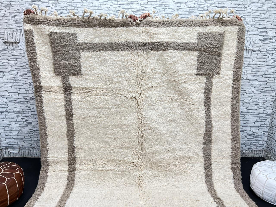 Beige minimalist Moroccan wool rug with geometric border pattern