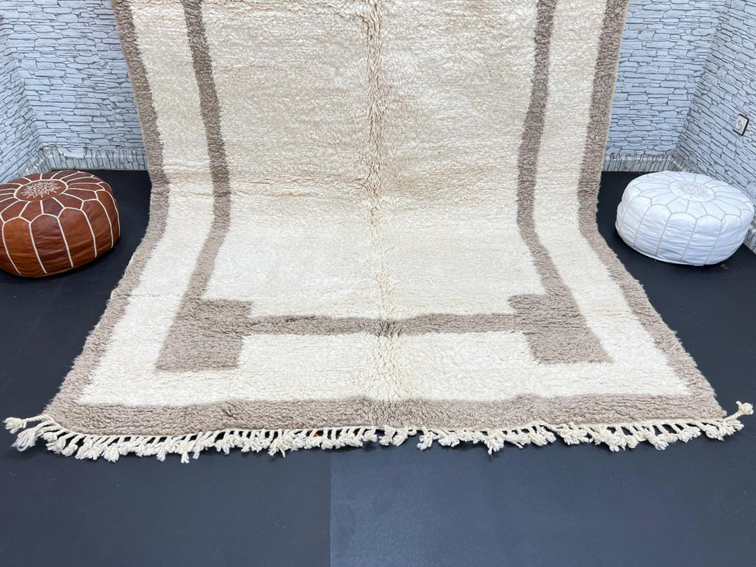 Beige minimalist Moroccan wool rug with geometric border pattern