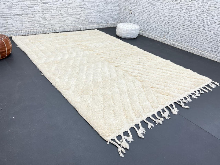 Handwoven beige Moroccan wool rug with minimalist geometric carved pattern