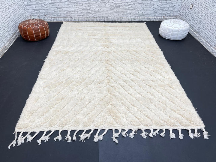 Handwoven beige Moroccan wool rug with minimalist geometric carved pattern