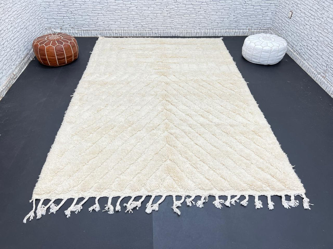 Handwoven beige Moroccan wool rug with minimalist geometric carved pattern