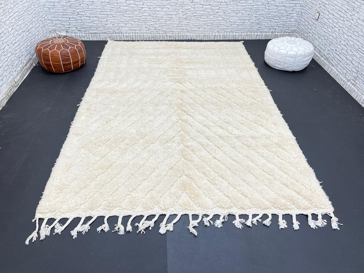 Handwoven beige Moroccan wool rug with minimalist geometric carved pattern
