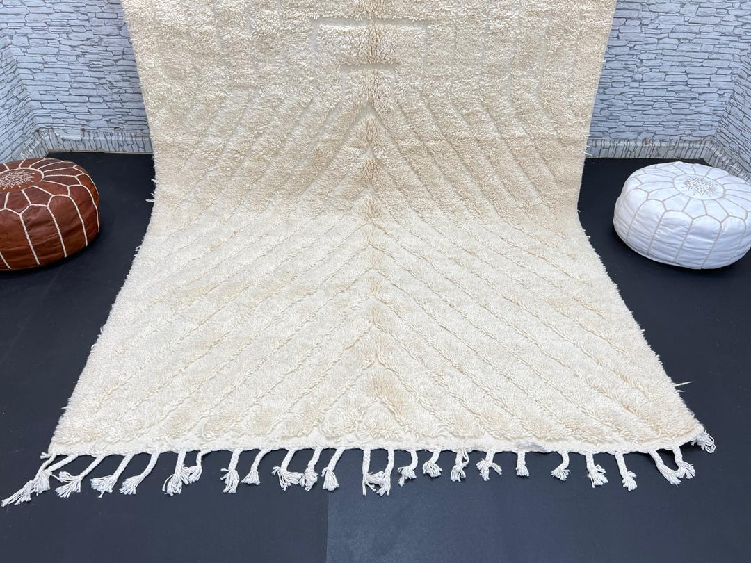 Handwoven beige Moroccan wool rug with minimalist geometric carved pattern