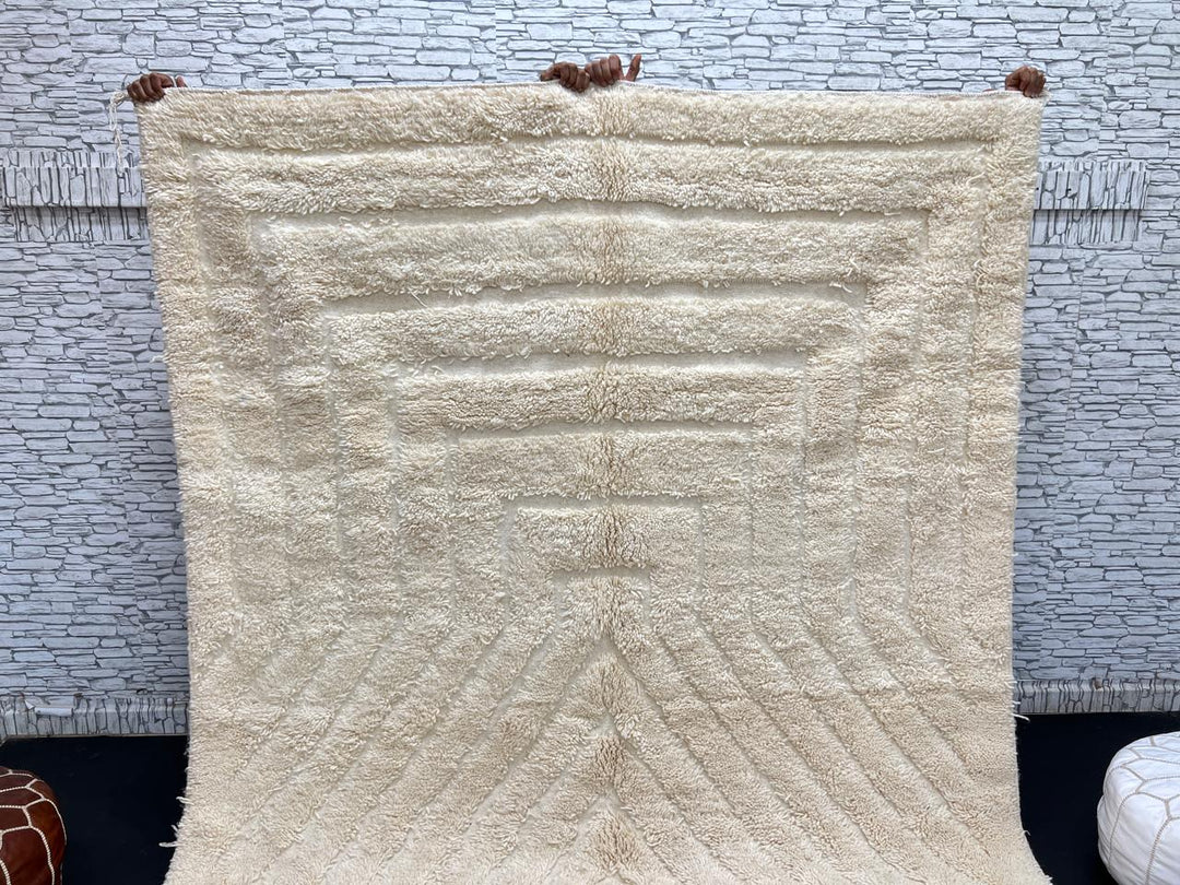 Handwoven beige Moroccan wool rug with minimalist geometric carved pattern