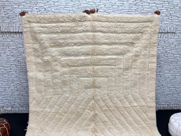 Handwoven beige Moroccan wool rug with minimalist geometric carved pattern