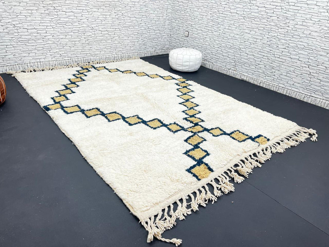 Beige Moroccan wool rug with black geometric diamond pattern, handmade by Berber artisans