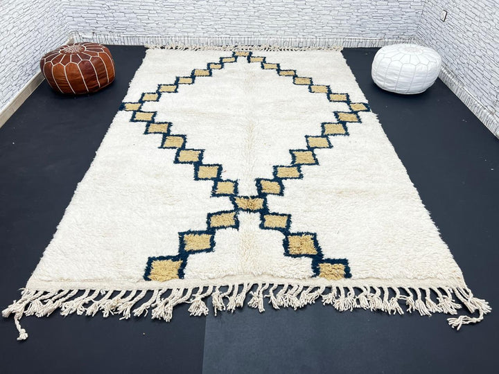 Beige Moroccan wool rug with black geometric diamond pattern, handmade by Berber artisans