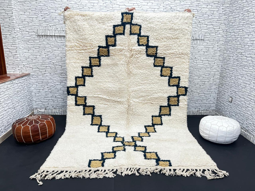 Beige Moroccan wool rug with black geometric diamond pattern, handmade by Berber artisans