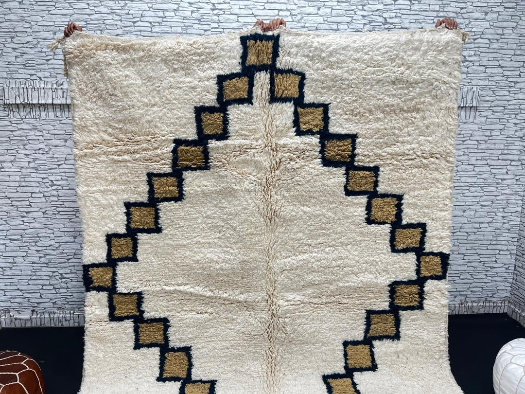 Beige Moroccan wool rug with black geometric diamond pattern, handmade by Berber artisans