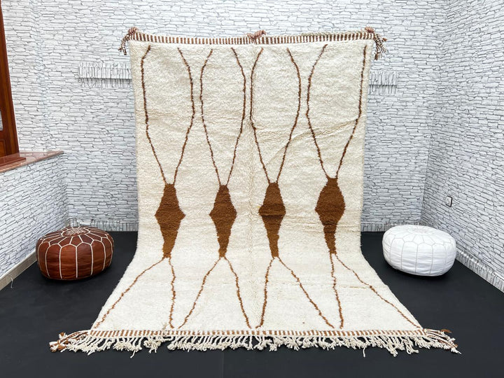 Beige and brown Moroccan wool rug with geometric design, handmade by Berber artisans using natural wool