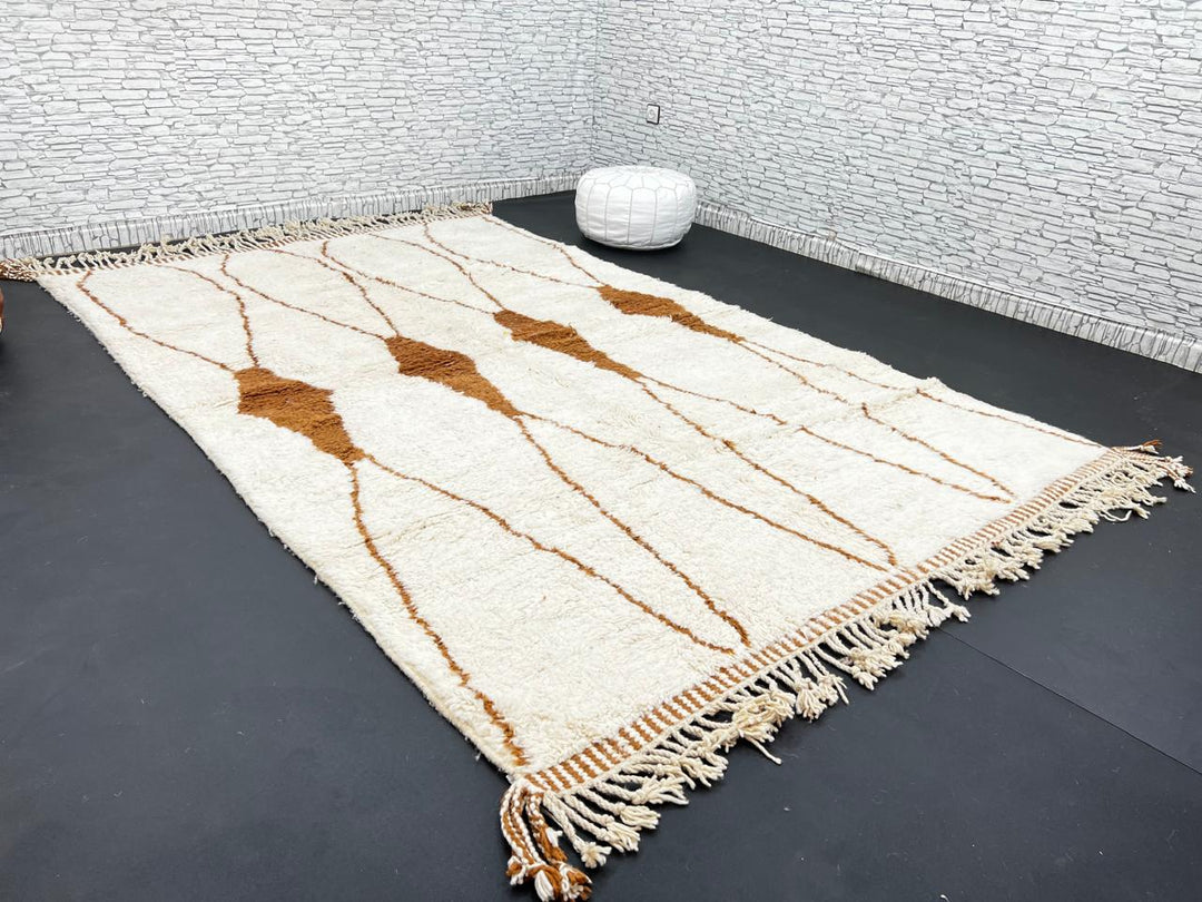 Beige and brown Moroccan wool rug with geometric design, handmade by Berber artisans using natural wool