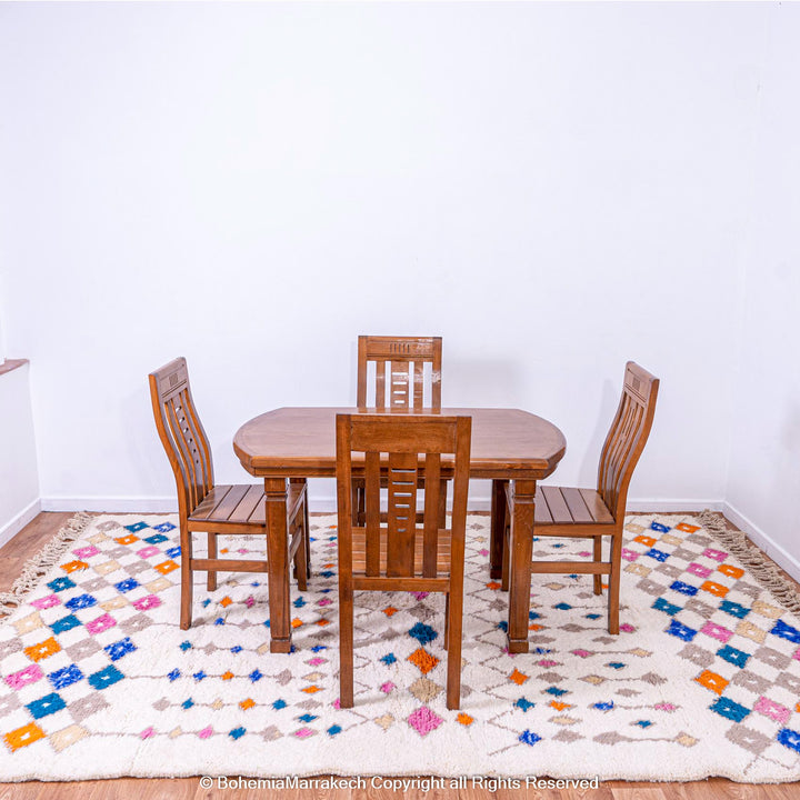 Handmade Moroccan rug with colorful diamond pattern on ivory wool background