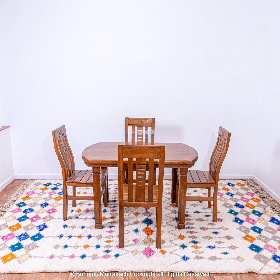 Handmade Moroccan rug with colorful diamond pattern on ivory wool background