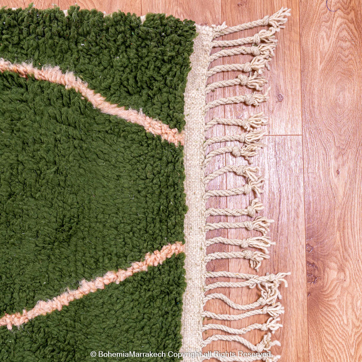 Green Moroccan rug with pink abstract desert motif design, handmade in wool