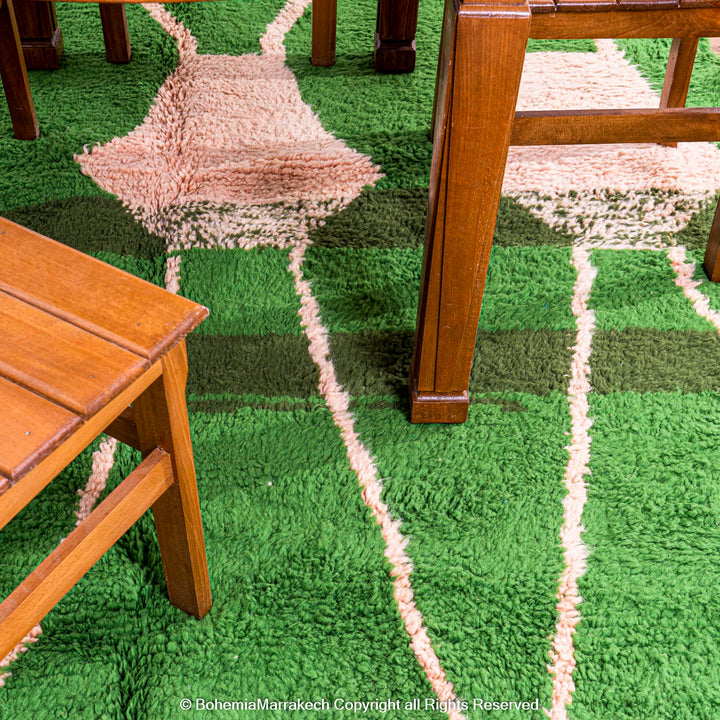 Green Moroccan rug with pink abstract desert motif design, handmade in wool