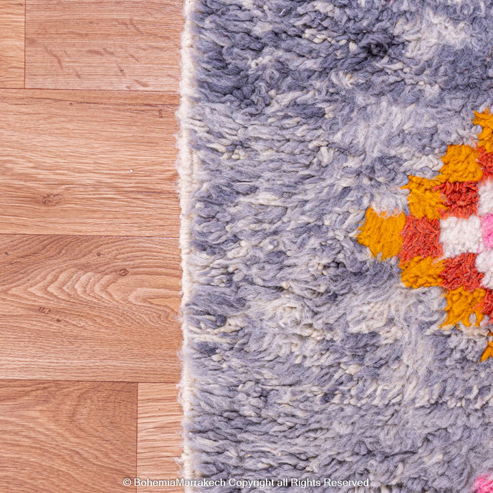 Colorful diamond Moroccan wool rug with grey shag background
