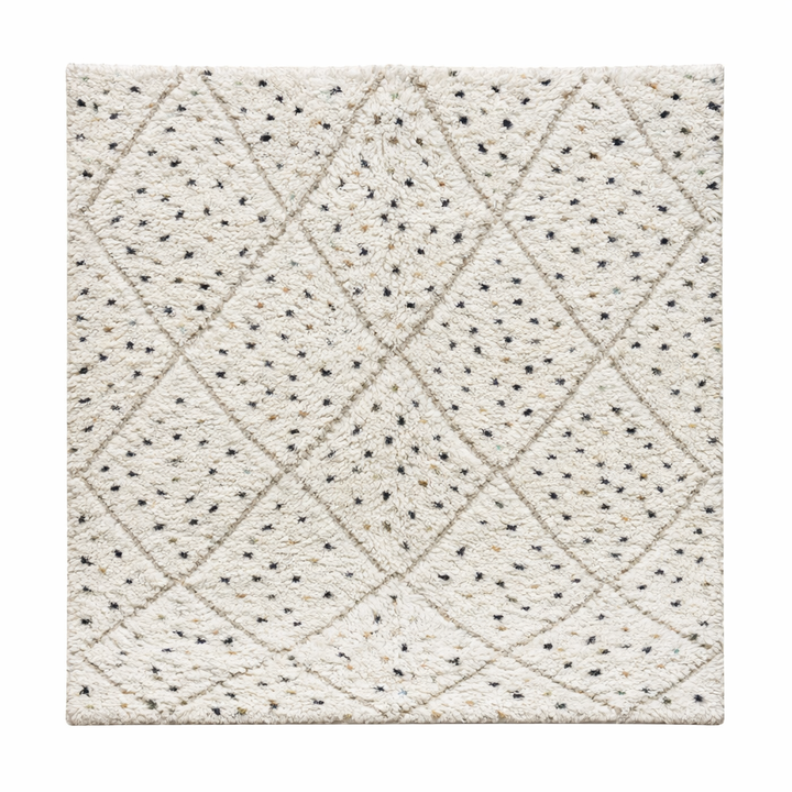 Handmade Moroccan wool rug with ivory base, diamond Berber pattern and subtle speckled accents. Soft plush texture, artisan crafted.