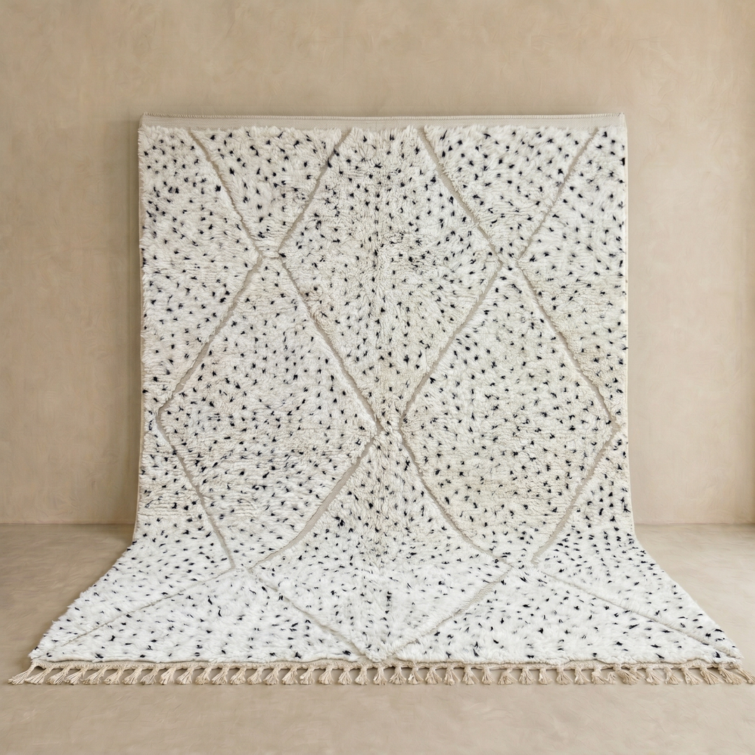 Handmade Moroccan wool rug with ivory base, diamond Berber pattern and subtle speckled accents. Soft plush texture, artisan crafted.