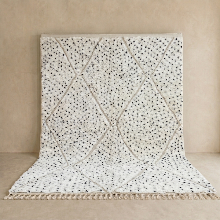Handmade Moroccan wool rug with ivory base, diamond Berber pattern and subtle speckled accents. Soft plush texture, artisan crafted.