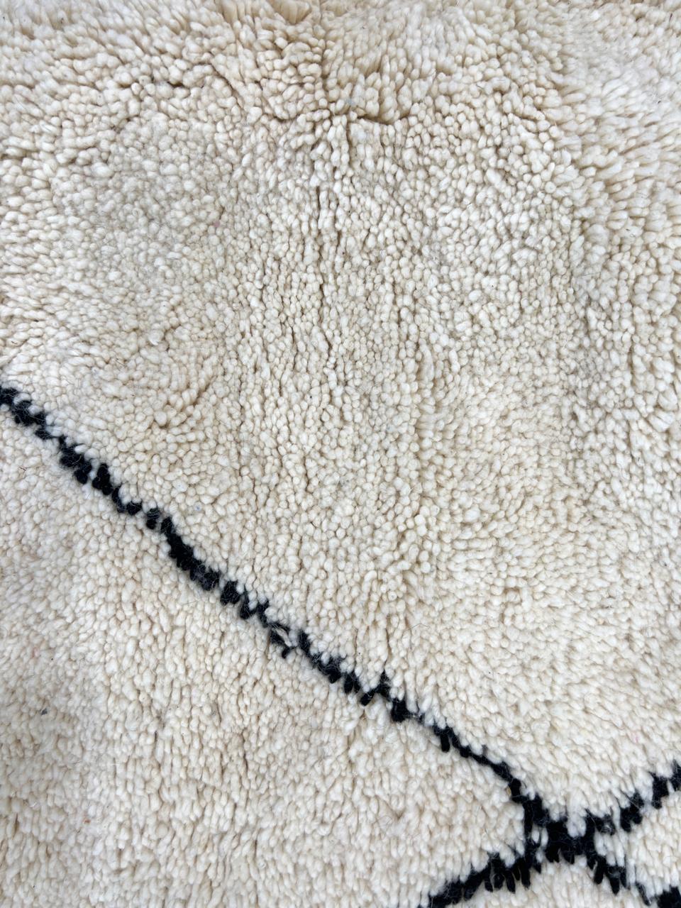 Black and white Beni Ourain Moroccan wool runner rug with diamond pattern and fringed edges