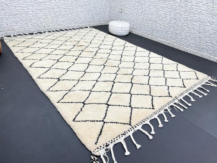 Handmade Moroccan Beni Ourain wool rug with black diamond pattern on ivory background