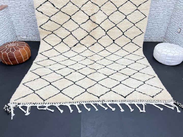 Handmade Moroccan Beni Ourain wool rug with black diamond pattern on ivory background