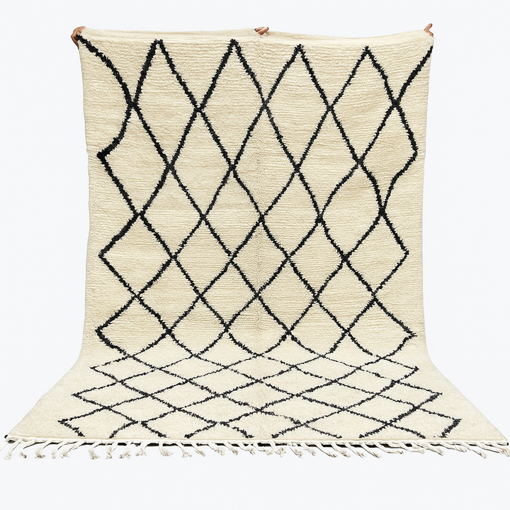 Handwoven Beni Ourain Moroccan wool rug with black diamond pattern on ivory background