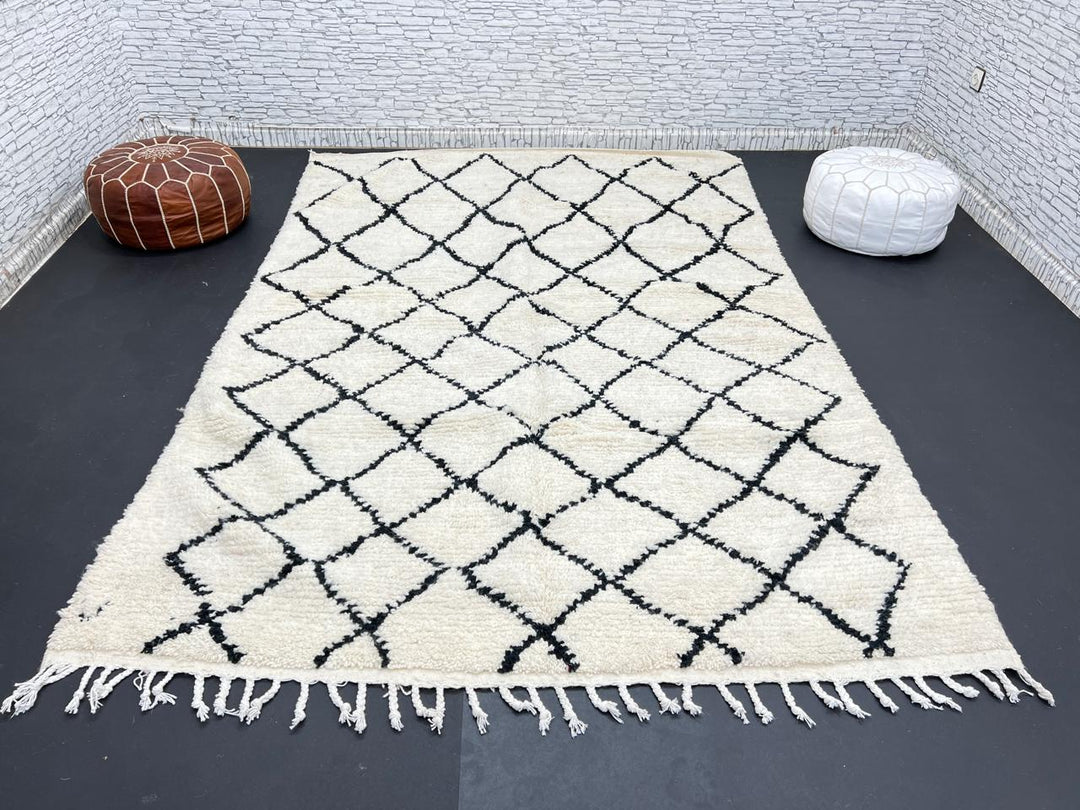 Handwoven Beni Ourain Moroccan wool rug with black diamond pattern on ivory background