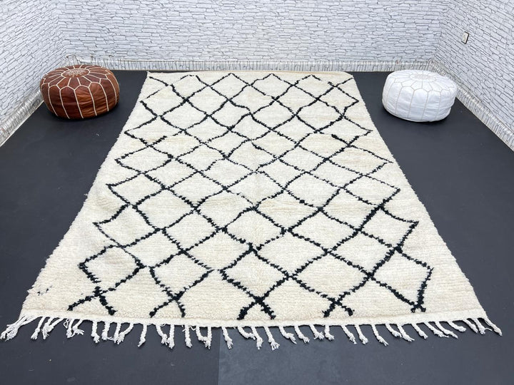 Handwoven Beni Ourain Moroccan wool rug with black diamond pattern on ivory background