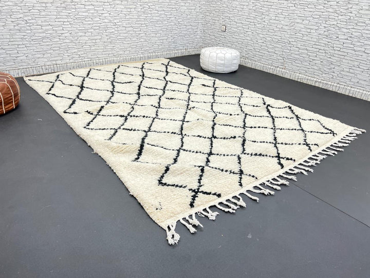 Handwoven Beni Ourain Moroccan wool rug with black diamond pattern on ivory background