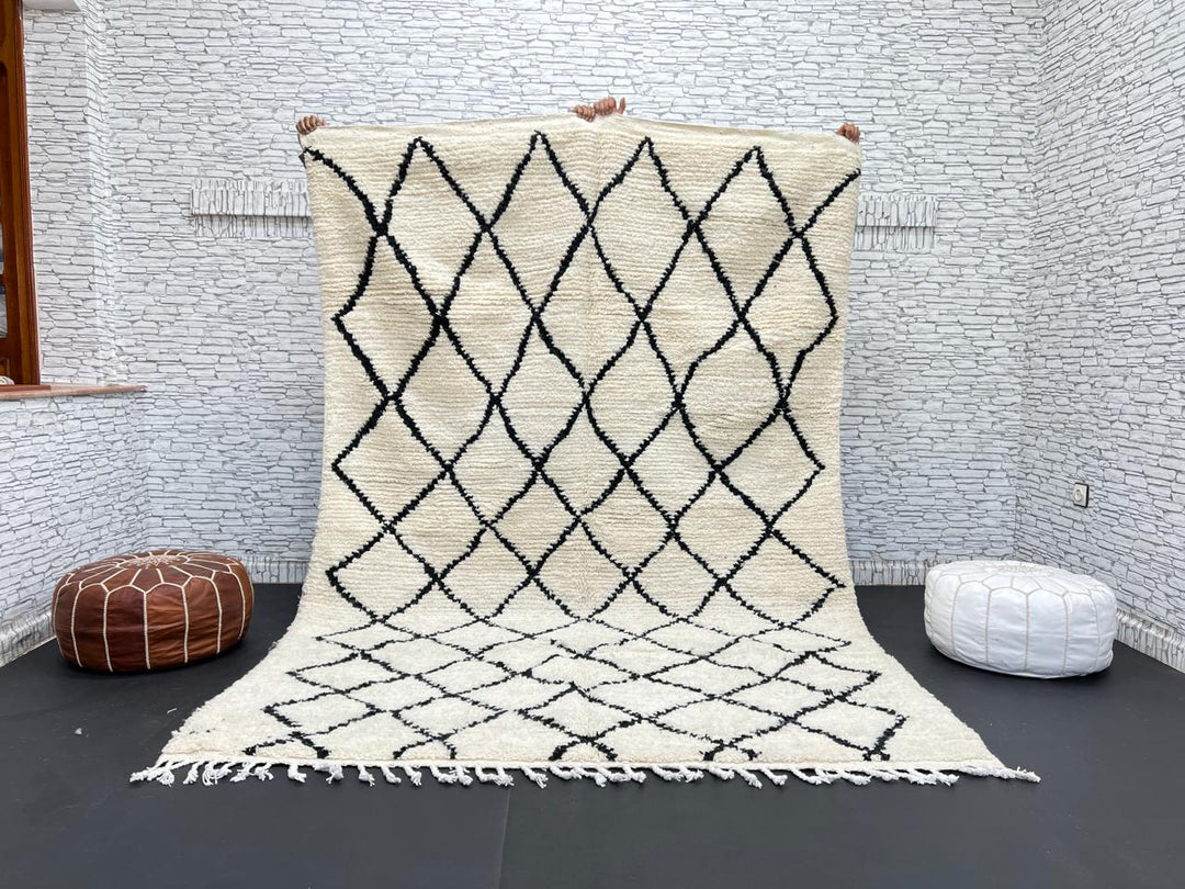 Handwoven Beni Ourain Moroccan wool rug with black diamond pattern on ivory background