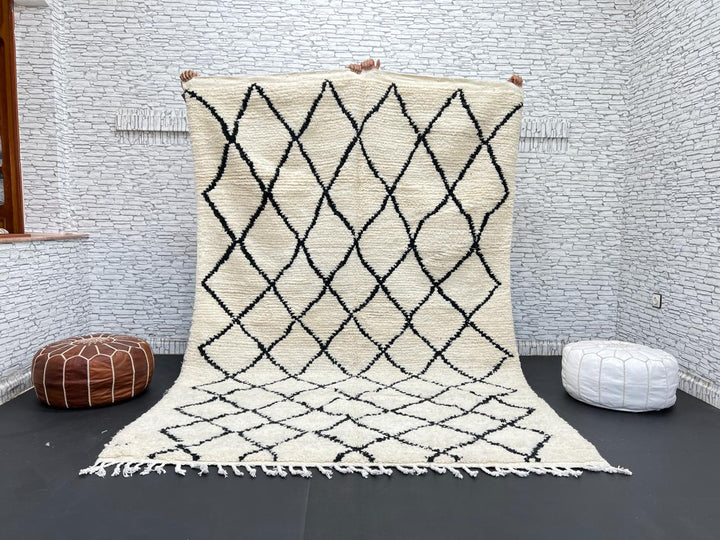 Handwoven Beni Ourain Moroccan wool rug with black diamond pattern on ivory background