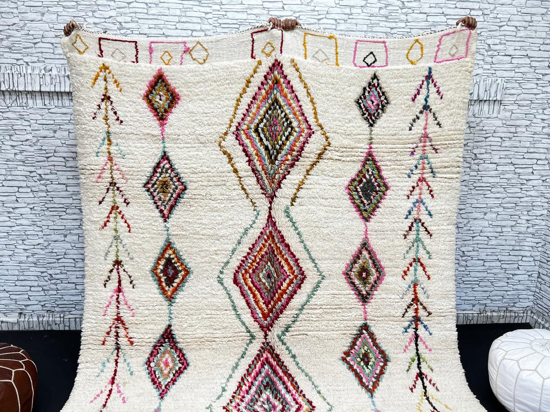 Beni Ourain Moroccan wool rug with cream background and colorful diamond motifs, handmade by Berber artisans