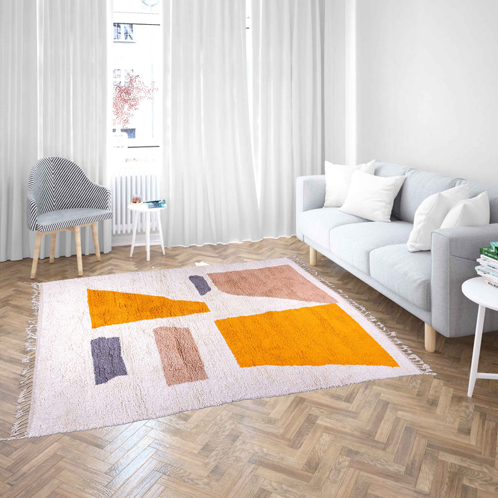 Handmade Moroccan wool rug with abstract orange and beige block design on cream background