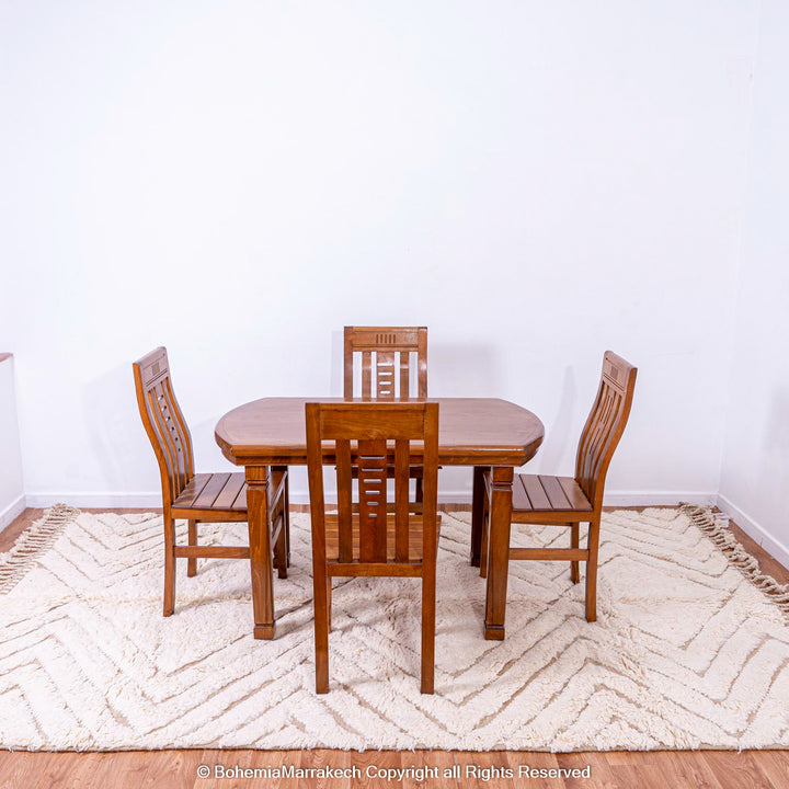 Handmade Beni Ourain Moroccan wool rug under wooden dining set in minimalist room.