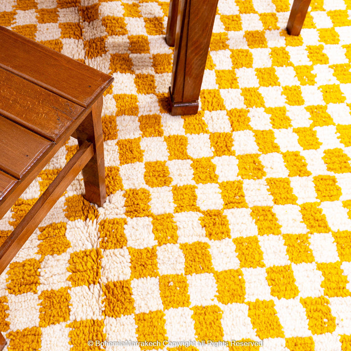 Handwoven Moroccan rug in yellow and white checkerboard pattern, crafted from soft wool