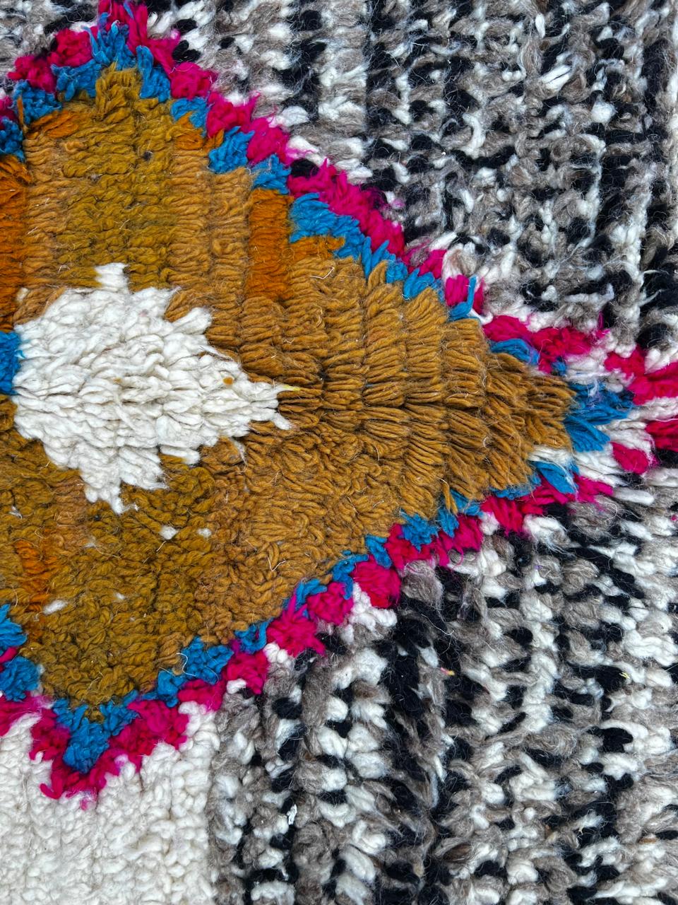 Handmade round Moroccan wool rug with traditional Berber symbols and tribal patterns on white background