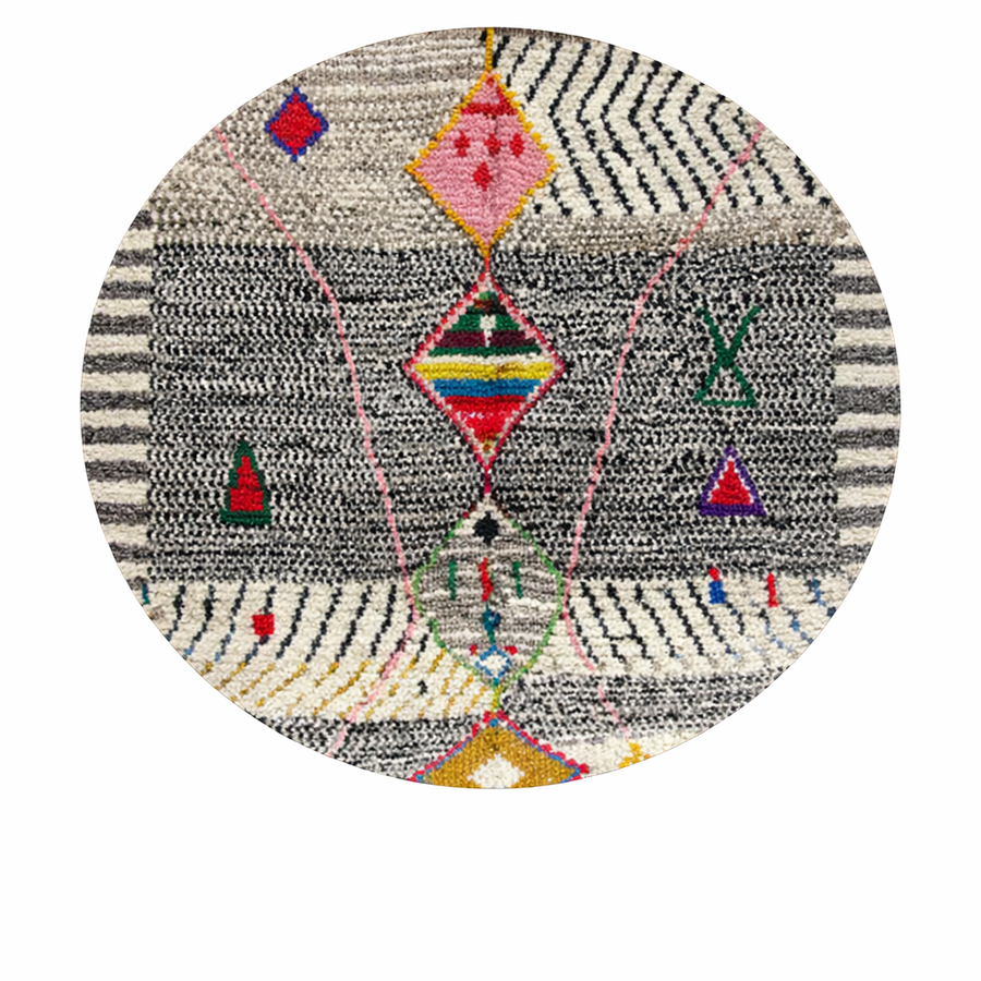 Handmade round Moroccan wool rug with traditional Berber symbols and tribal patterns on white background