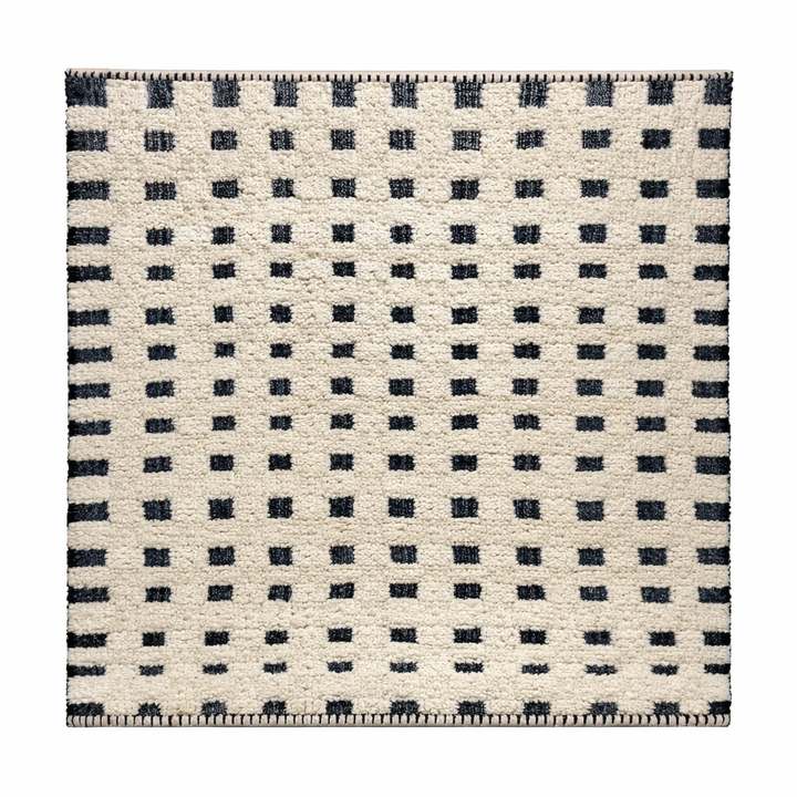 Handmade Moroccan wool rug with ivory base and subtle black square grid. Soft plush texture, minimalist style, artisan crafted.