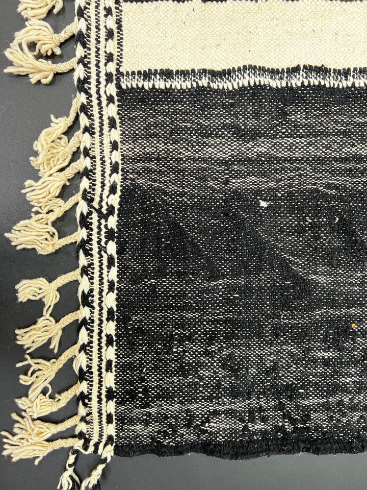 Black and white Moroccan kilim runner rug with central white stripe, handwoven flatweave wool carpet in minimalist design, perfect as hallway Moroccan runner and modern boho floor decor.