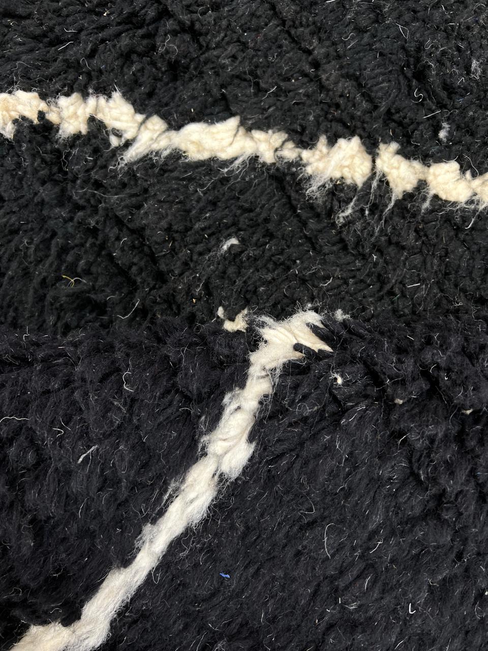 Black and white Moroccan wool rug with modern geometric line design