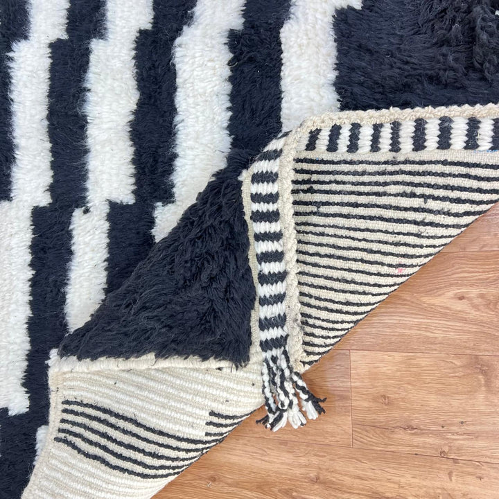 Black and white Moroccan Berber runner rug with geometric wool pattern, handmade hallway runner