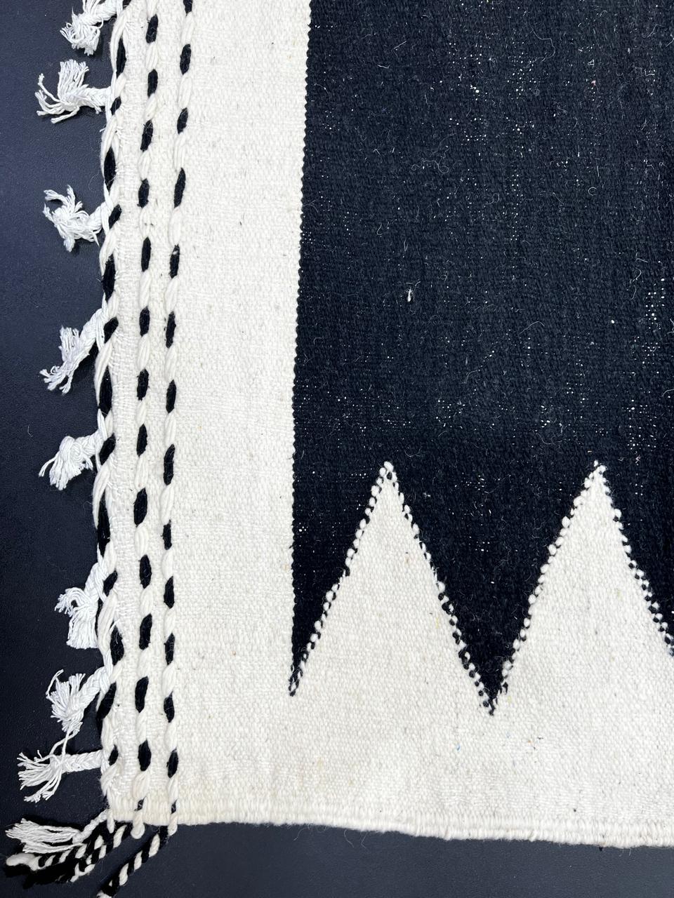 Handmade black and white Moroccan kilim runner rug with bold zigzag geometric design and flatwoven Berber pattern